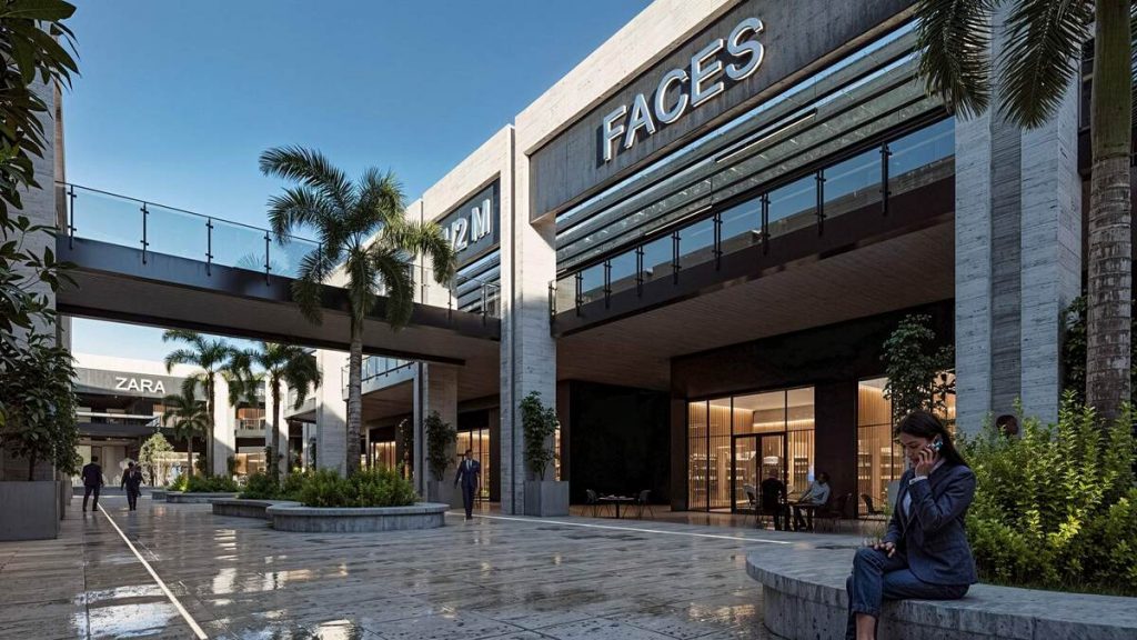 تصميم معماري لمجمع تجاري حديث بطراز عصري، يجمع بين الخرسانة المكشوفة والواجهات الزجاجية في بيئة حضرية منسقة.